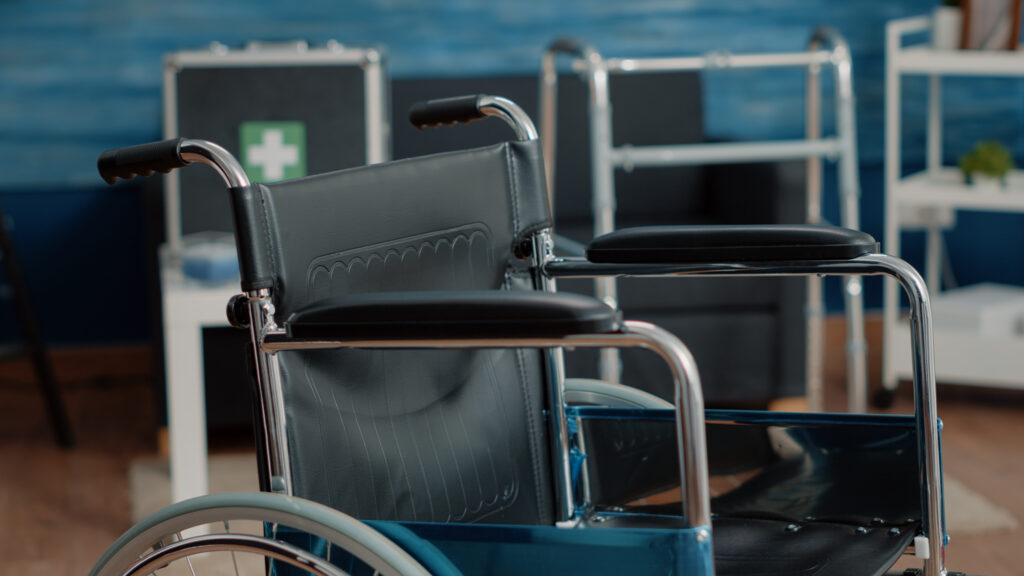 Close up of wheelchair in empty nursing home at clinic. Object of transportation for accessibility and people with invalidity. Chair used for support and rehabilitation, helping with mobility.
